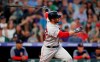 Boston Red Sox's J.D. Martinez follows the flight of his two-run home run off Colorado Rockies starting pitcher Peter Lambert in the top of the third inning of a baseball game Wednesday, Aug. 28, 2019, in Denver. (AP Photo/David Zalubowski)