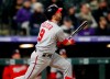 Washington Nationals' Brian Dozier follows the flight of his three-run home run off Colorado Rockies starting pitcher Tyler Anderson in the fourth inning of a baseball game Monday, April 22, 2019, in Denver. (AP Photo/David Zalubowski)