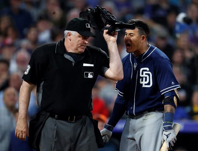 San Diego Padres' Manny Machado, right, yells at home plate umpire Bill Welke, who had called Machado out on strikes during the fifth inning of the team's baseball game against the Colorado Rockies on Saturday, June 15, 2019, in Denver. (AP Photo/David Zalubowski)