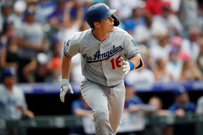 Los Angeles Dodgers' Will Smith watches his three-run home run off Colorado Rockies' Wade Davis during the ninth inning of a baseball game Wednesday, July 31, 2019, in Denver. The Dodgers won 5-1. (AP Photo/David Zalubowski)