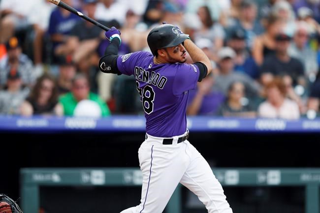 Colorado Rockies' Nolan Arenado follows the flight of his solo home run off San Francisco Giants starting pitcher Andrew Suarez in the fifth inning of a baseball game Sunday, Aug. 4, 2019, in Denver. (AP Photo/David Zalubowski)