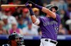 Colorado Rockies' David Dahl follows the flight of his double off Washington Nationals relief pitcher Matt Grace in the sixth inning of a baseball game Wednesday, April 24, 2019, in Denver. (AP Photo/David Zalubowski)