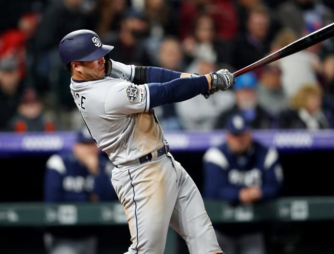 San Diego Padres' Ty France watches his RBI single off Colorado Rockies starting pitcher German Marquez during the fifth inning of a baseball game Friday, May 10, 2019, in Denver. (AP Photo/David Zalubowski)