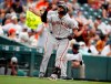 San Francisco Giants' Donovan Solano, front, gestures as he circles the bases after hitting a solo home run off Colorado Rockies starting pitcher Jon Gray in the sixth inning of a baseball game Wednesday, July 17, 2019, in Denver. San Francisco Giants third base coach Ron Wotus, back, looks on. (AP Photo/David Zalubowski)
