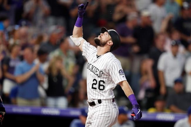 Colorado Rockies' David Dahl gestures as he crosses home plate after hitting a two-run home run off Los Angeles Dodgers starting pitcher Hyun-Jin Ryu in the fifth inning of a baseball game Friday, June 28, 2019, in Denver. (AP Photo/David Zalubowski)
