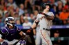 San Francisco Giants' Mike Yastrzemski watches his two-run home run next to Colorado Rockies catcher Tony Wolters during the fifth inning of a baseball game Friday, Aug. 2, 2019, in Denver. (AP Photo/David Zalubowski)