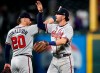 Atlanta Braves shortstop Dansby Swanson, front, is congratulated by third baseman Josh Donaldson after the Braves retired the Colorado Rockies in the ninth inning of a baseball game Monday, April 8, 2019, in Denver. The Braves won 8-6. (AP Photo/David Zalubowski)
