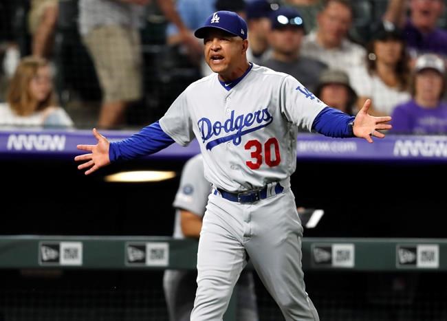 Los Angeles Dodgers manager Dave Roberts comes out of the dugout to argue with home plate umpire Laz Diaz during the eighth inning of the team's baseball game against the Colorado Rockies on Friday, June 28, 2019, in Denver. (AP Photo/David Zalubowski)