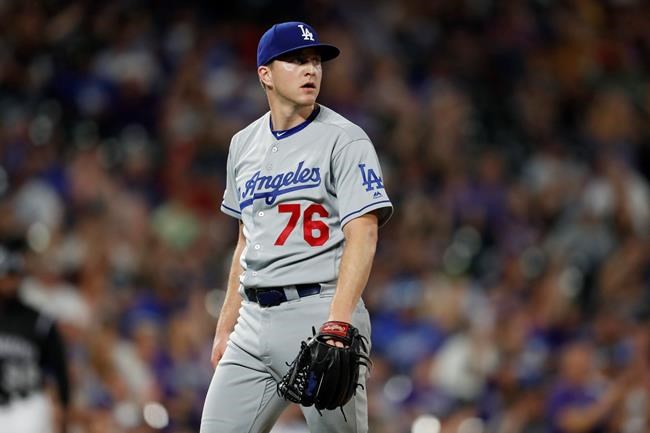 Los Angeles Dodgers relief pitcher Josh Sborz reacts after giving up a two-run home run to Colorado Rockies' David Dahl in the eighth inning of a baseball game Monday, July 29, 2019, in Denver. (AP Photo/David Zalubowski)
