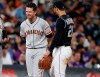 San Francisco Giants pinch-hitter Buster Posey, left, jokes with Colorado Rockies third baseman Nolan Arenado during a pitching change in the eighth inning of a baseball game Saturday, Aug. 3, 2019, in Denver. (AP Photo/David Zalubowski)