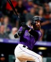 Colorado Rockies' Charlie Blackmon watches his two-run triple off San Diego Padres starting pitcher Matt Wisler during the seventh inning of a baseball game Thursday, June 13, 2019, in Denver. (AP Photo/David Zalubowski)