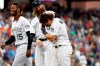 Colorado Rockies' Tony Wolters, front, is congratulated by Charlie Blackmon, center, as Raimel Tapia joins in after Wolters hit a sacrifice fly to bring in the winning run off Baltimore Orioles relief pitcher Mychal Givens in the ninth inning of a baseball game Sunday, May 26, 2019, in Denver. (AP Photo/David Zalubowski)