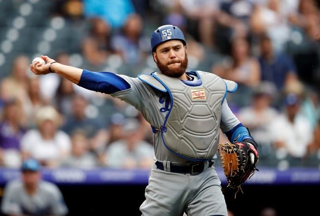 Los Angeles Dodgers catcher Russell Martin throws to first base to put out Colorado Rockies' Ian Desmond in the ninth inning of a baseball game Sunday, June 30, 2019, in Denver. (AP Photo/David Zalubowski)