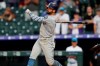 San Diego Padres' Greg Garcia follows the flight of his triple to drive in two runs off Colorado Rockies relief pitcher Wade Davis in the ninth inning of a baseball game Sunday, June 16, 2019, in Denver. (AP Photo/David Zalubowski)