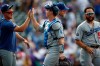 Los Angeles Dodgers' Enrique Hernandez, left, congratulates catcher Will Smith as catcher Russell Martin stands nearby after a baseball game against the Colorado Rockies on Wednesday, July 31, 2019, in Denver. The Dodgers won 5-1. (AP Photo/David Zalubowski)