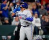 Toronto Blue Jays' Vladimir Guerrero Jr. gestures as he circles the bases after hitting a solo home run off Colorado Rockies relief pitcher Chris Rusin during the eighth inning of a baseball game Friday, May 31, 2019, in Denver. (AP Photo/David Zalubowski)