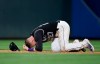 Colorado Rockies shortstop Trevor Story falls to the infield after taking a ground ball to the face on a single by San Diego Padres' Hunter Renfroe during the eighth inning of a baseball game Friday, June 14, 2019, in Denver. (AP Photo/David Zalubowski)