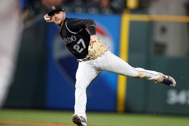 Colorado Rockies shortstop Trevor Story throws to first base to put out Arizona Diamondbacks' Nick Ahmed during the sixth inning of a baseball game Wednesday, May 29, 2019, in Denver. (AP Photo/David Zalubowski)