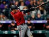Arizona Diamondbacks' Carson Kelly swings for a solo home run off Colorado Rockies relief pitcher Seunghwan Oh during the sixth inning of a baseball game Wednesday, May 29, 2019, in Denver. (AP Photo/David Zalubowski)