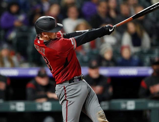 Arizona Diamondbacks' Carson Kelly swings for a solo home run off Colorado Rockies relief pitcher Seunghwan Oh during the sixth inning of a baseball game Wednesday, May 29, 2019, in Denver. (AP Photo/David Zalubowski)