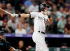 Colorado Rockies' Ryan McMahon watches his solo home run off Miami Marlins relief pitcher Wei-Yin Chen during the seventh inning of a baseball game Saturday, Aug. 17, 2019, in Denver. (AP Photo/David Zalubowski)