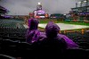 Fans sit in the rain prior to a scheduled baseball game between the San Francisco Giants and the Colorado Rockies on Wednesday, May 8, 2019, in Denver. The game was postponed until July 15. (AP Photo/Jack Dempsey)