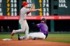 Philadelphia Phillies second baseman Scott Kingery throws to first after forcing out Colorado Rockies' Charlie Blackmon (19) during the third inning of a baseball game Thursday, April 18, 2019, in Denver. David Dahl was safe at first. (AP Photo/Jack Dempsey)
