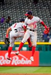 Washington Nationals center fielder Victor Robles (16) and Wilmer Difo celebrate a 6-3 win against the Colorado Rockies following a baseball game, Tuesday, April 23, 2019, in Denver. (AP Photo/Jack Dempsey)