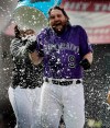 Colorado Rockies' Daniel Murphy is doused by a teammate after Murphy drove in the winning run in the 10th inning of the team's baseball game against the Arizona Diamondbacks in Denver, Thursday, May 30, 2019. Colorado won 11-10. (AP Photo/Joe Mahoney)