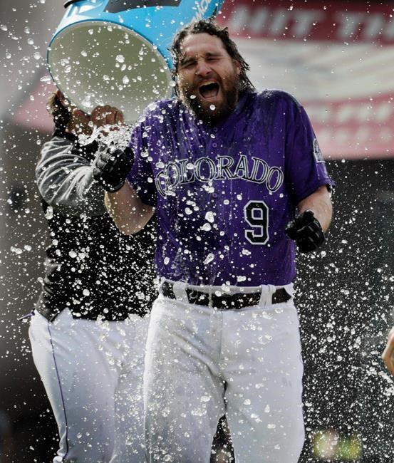 Colorado Rockies' Daniel Murphy is doused by a teammate after Murphy drove in the winning run in the 10th inning of the team's baseball game against the Arizona Diamondbacks in Denver, Thursday, May 30, 2019. Colorado won 11-10. (AP Photo/Joe Mahoney)