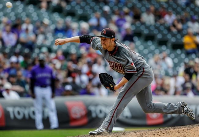 Arizona Diamondbacks relief pitcher Yoshihisa Hirano throws during the 10th inning of a baseball game against the Colorado Rockies in Denver, Thursday, May 30, 2019. (AP Photo/Joe Mahoney)