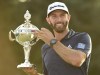 Dustin Johnson, of the United States, hoists the Canadian Open championship trophy at the Glen Abbey Golf Club in Oakville, Ont., on July 29, 2018. A couple of key changes have stacked the odds against Dustin Johnson as he tries to defend his RBC Canadian Open title. THE CANADIAN PRESS/Nathan Denette