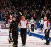 Team Ontario sub Craig Savill, front left, waves to the crowd as he gets a congratulations from Team Canada third John Morris, centre, and lead Nolan Thiessen, right, after Savill delivered a stone in draw 16 at the Brier curling championship in Ottawa on Thursday, March 10, 2016. Craig Savill received a huge ovation when he led Team Canada's walkout for the introductions Thursday night at the Tim Hortons Brier. He nearly blew the roof off of TD Place when he put on his Team Ontario jacket and returned to the ice for a couple throws. THE CANADIAN PRESS/HO - Michael Burns