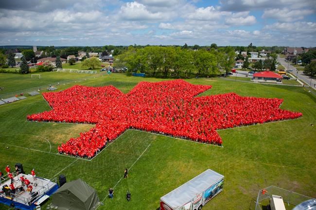People wear red to form a giant maple leaf in Trenton, Ont. on Saturday, June 29, 2019 in this handout photo. An Ontario municipality now has bragging rights for setting the record for the largest human maple leaf over the Canada Day long weekend. On Saturday, 3,942 people participated in forming a maple leaf in a Trenton, Ont. park. THE CANADIAN PRESS/HO, One Ram Media *MANDATORY CREDIT*