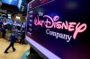 FILE - In this Monday, Aug. 7, 2017, file photo, The Walt Disney Co. logo appears on a screen above the floor of the New York Stock Exchange. Disney Plus has launched in Canada, becoming the newest arrival in the growing menu of TV options. THE CANADIAN PRESS/AP Photo/Richard Drew, File