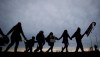 First Nations Idle No More protesters hold hands and dance in a circle during a demonstration at the Douglas-Peace Arch crossing on the Canada-U.S. border near Surrey, B.C., on Saturday January 5, 2013. Aboriginal peoples are gaining ground in Canada's population, but they are losing their languages, according to the National Household Survey. THE CANADIAN PRESS/Darryl Dyck