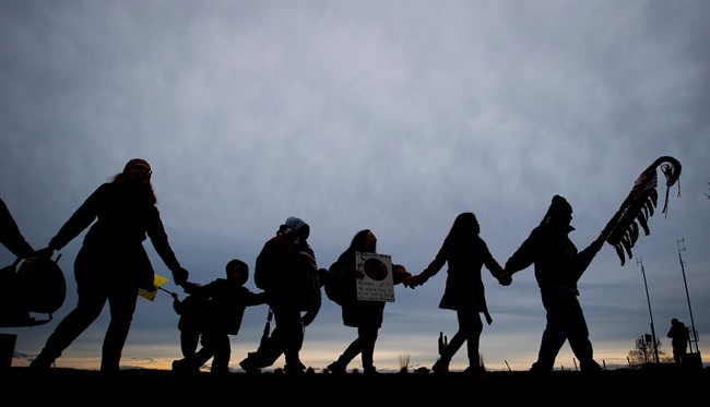 First Nations Idle No More protesters hold hands and dance in a circle during a demonstration at the Douglas-Peace Arch crossing on the Canada-U.S. border near Surrey, B.C., on Saturday January 5, 2013. Aboriginal peoples are gaining ground in Canada's population, but they are losing their languages, according to the National Household Survey. THE CANADIAN PRESS/Darryl Dyck