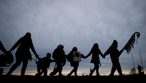 First Nations Idle No More protesters hold hands and dance in a circle during a demonstration at the Douglas-Peace Arch crossing on the Canada-U.S. border near Surrey, B.C., on Saturday January 5, 2013. Aboriginal peoples are gaining ground in Canada's population, but they are losing their languages, according to the National Household Survey. THE CANADIAN PRESS/Darryl Dyck