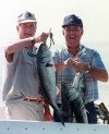U. S. President George Bush and Canadian Prime Minister Brian Mulroney hold up blue fish they caught during a fishing expedition near Kennebunkport, Maine, Aug. 28, 1990. THE CANADIAN PRESS/Ron Poling