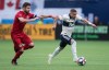 Vancouver Whitecaps' Lucas Venuto, right, runs with the ball as Toronto FC's Drew Moor attempts to stop him during the first half of an MLS soccer game in Vancouver on May 31, 2019. It's a role he has held in the past with the Colorado Rapids, but it was a special night for Toronto FC veteran Drew Moor when he donned the captain's armband in their last game on June 7.