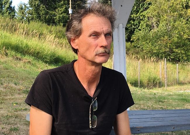 The father of a British Columbia murder suspect has written a book that sheds new light on his mental health, explains harassment convictions involving his ex-wife and provides greater insight into the possible impacts the events had on his fugitive son. Alan Schmegelsky, father of Bryer Schmegelsky, poses for a photo during an interview with The Canadian Press in Mill Bay, B.C., Wednesday, July 24, 2019. THE CANADIAN PRESS/Laura Kane