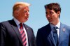 U.S. President Donald Trump talks with Canadian Prime Minister Justin Trudeau during a G-7 Summit welcome ceremony in Charlevoix, Canada on June 8, 2018. The top Canadian organizer at last year's stormy G7 summit says Prime Minister Justin Trudeau kept a 