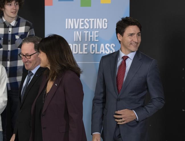 Prime Minister Justin Trudeau, right, arrives for a speech to students at Alma College, Thursday, April 4, 2019 in Alma Que. Lac St-Jean MP Richard Hebert, left, leads the way. The official campaign may be in its infancy, but over the summer Liberal politicians were already hard at work, roaming the country and making hundreds of spending announcements in Canadian ridings. THE CANADIAN PRESS/Jacques Boissinot