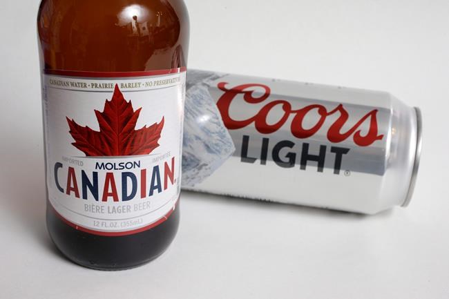 Molson Coors products Molson Canadian beer, left, and Coors Light beer are shown in Walpole, Mass., on November 28, 2017. THE CANADIAN PRESS/AP, Steven Senne