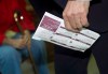 An advocacy group and a student organization say not allowing people to use voter identification cards as valid ID at the polls could disenfranchise tens of thousands of eligible voters in the upcoming federal election. Former Liberal Leader Michael Ignatieff holds his voter information card at a polling station during the 41st Canadian general election in Etobicoke, Ont., on May 2, 2011. THE CANADIAN PRESS/Nathan Denette