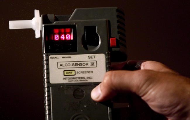 An RCMP Constable holds a breathalyzer test in Surrey, B.C., in this September 24, 2010 photo. Stricter drunk driving legislation takes effect across Canada tomorrow, giving police officers the right to demand a breath sample from any driver they lawfully stop. THE CANADIAN PRESS/Darryl Dyck