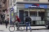 People pass a Capital One Bank in New York on Jan. 21, 2015. A prominent Ontario personal injury law firm has filed a class action on behalf of Canadians affected by the huge Capital One data breach that was disclosed last week. Diamond & Diamond's suit seeks compensation for Canadians who applied for credit cards from Capital One between 2005 and 2019. THE CANADIAN PRESS/AP, Mark Lennihan