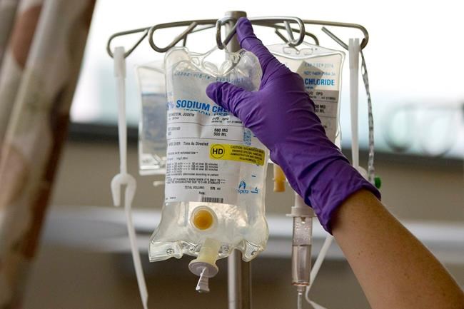 In this Tuesday, Aug. 4, 2015 file photo, a nurse places a patient's chemotherapy medication on an intravenous stand at a hospital in Philadelphia. New international research shows Canada has among the highest survival rates for lung cancer and colon cancer, but lags in survival rates for esophageal and rectal cancer. THE CANADIAN PRESS/AP/Matt Rourke, File
