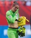 Canada goalkeeper Erin McLeod wipes tears from her eyes after losing 2-1 to England during a FIFA Women's World Cup quarter-final soccer game in Vancouver, B.C., on Saturday June 27, 2015. McLeod has confirmed the worst ??? a knee injury will keep her out of the Summer Olympics. THE CANADIAN PRESS/Darryl Dyck