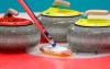 A broom and three stones are shown during the United States mixed doubles curling match against China at the 2018 Winter Olympics in Gangneung, South Korea, Saturday, Feb. 10, 2018. The experimenting is over for curling's five-rock rule. From the clubs to the world championships, curlers are adapting to the newest wrinkle in the sport this season. THE CANADIAN PRESS/AP/Aaron Favila